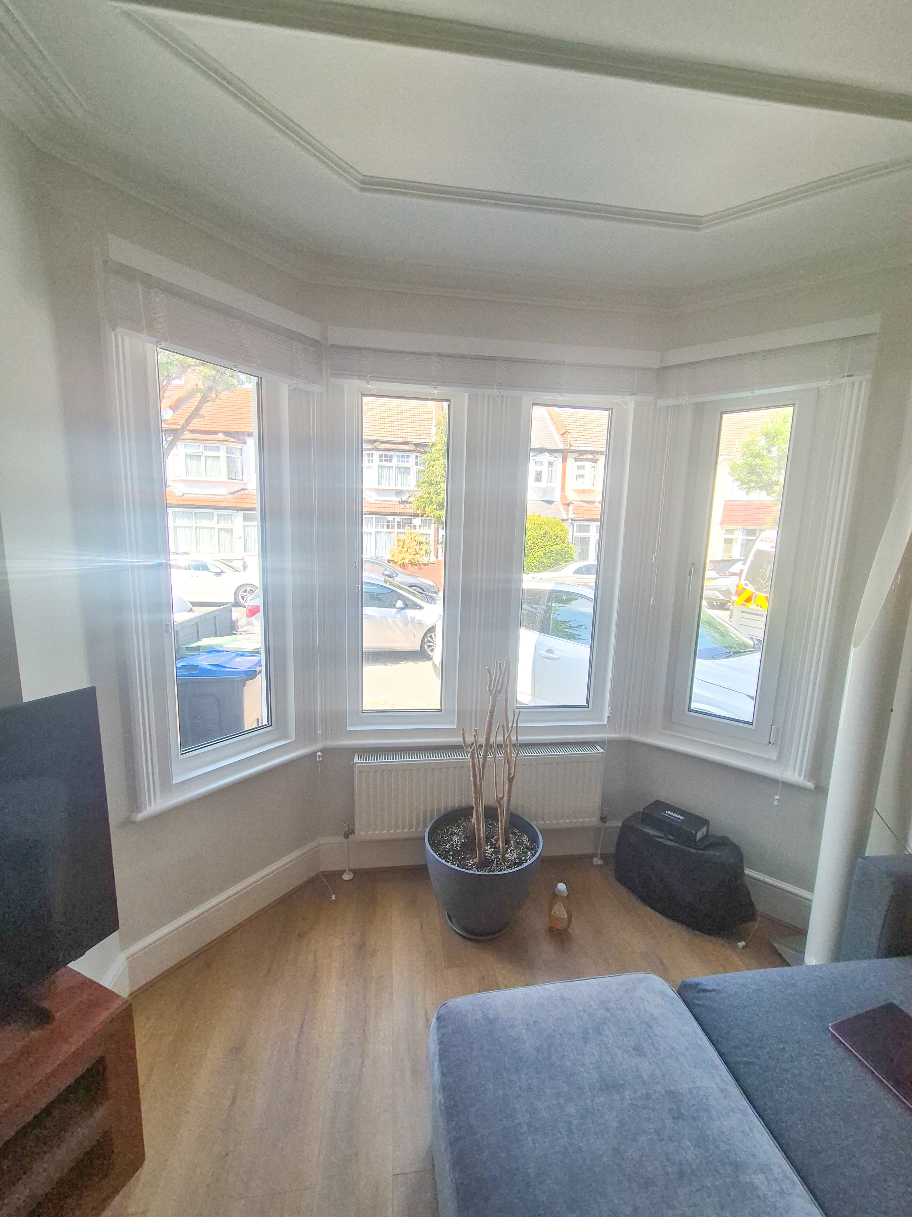 Untreated residential bay window in a Caversham home flooding the living room with intense sun glare before window film installation