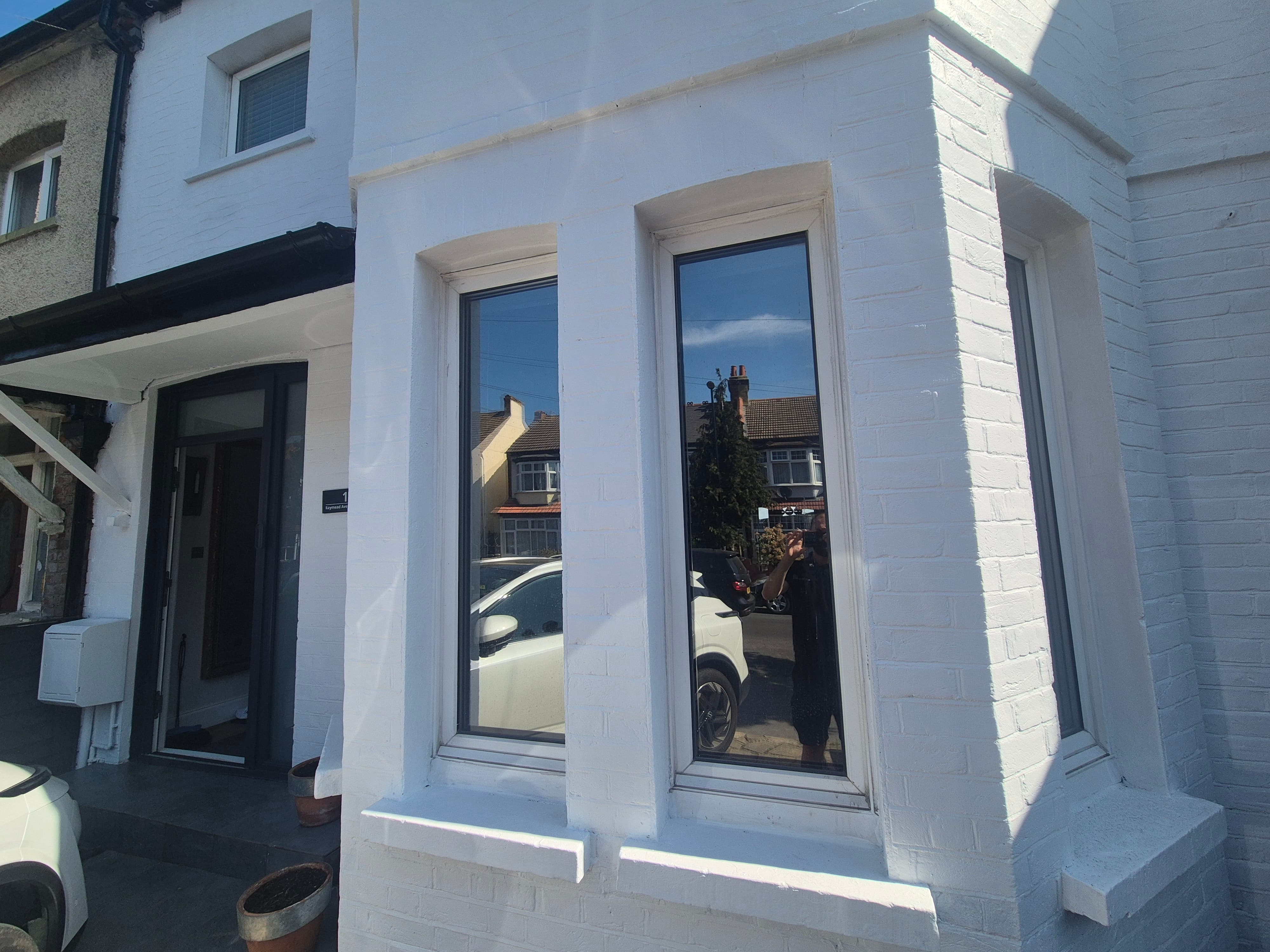 Completed silver reflective window film installation on a Reading bay window providing daytime privacy, 99% UV protection, and year-round thermal control