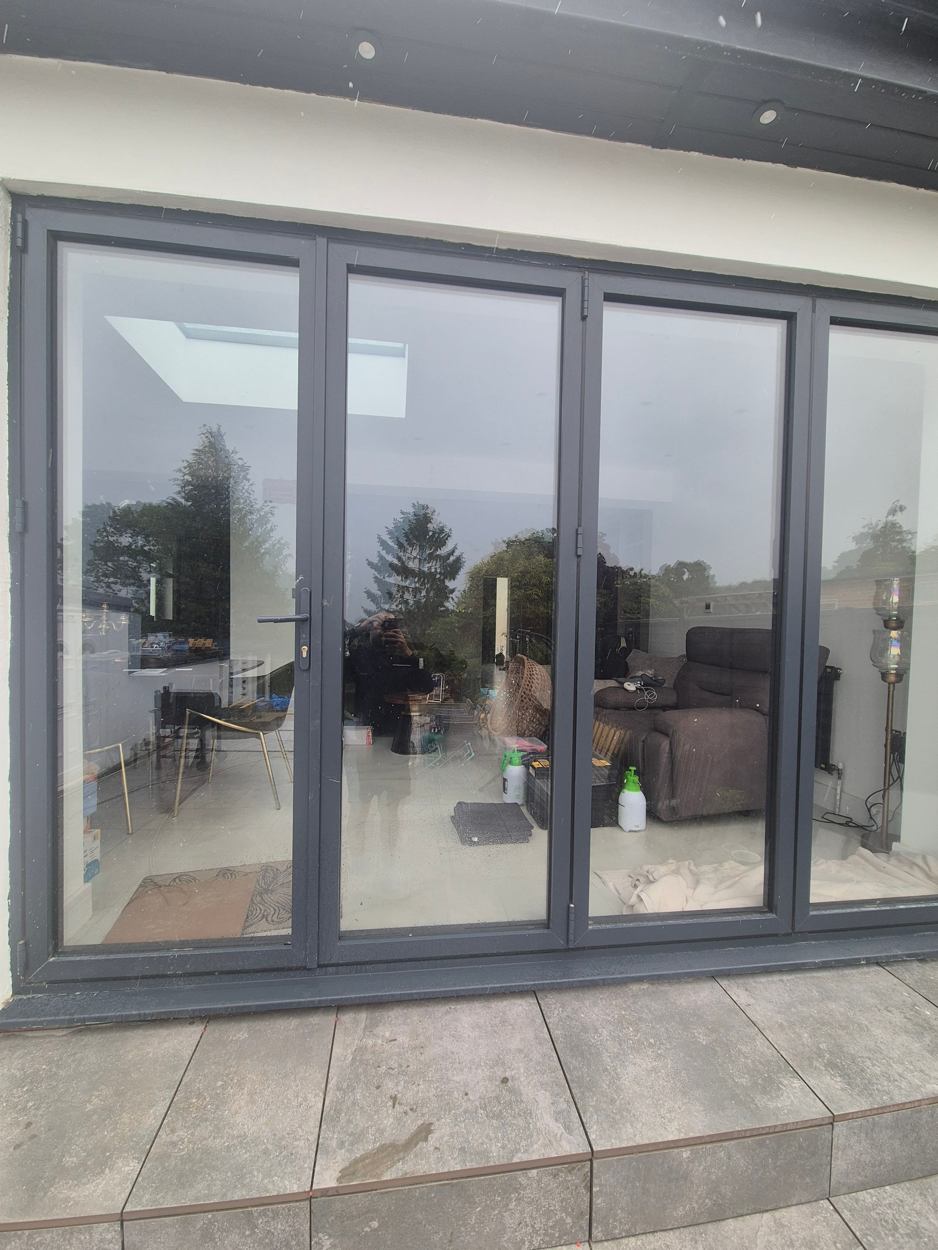 Four‑pane bifold doors in a Maidenhead Riverside home before window film installation, showing clear glass with glare and full visibility inside