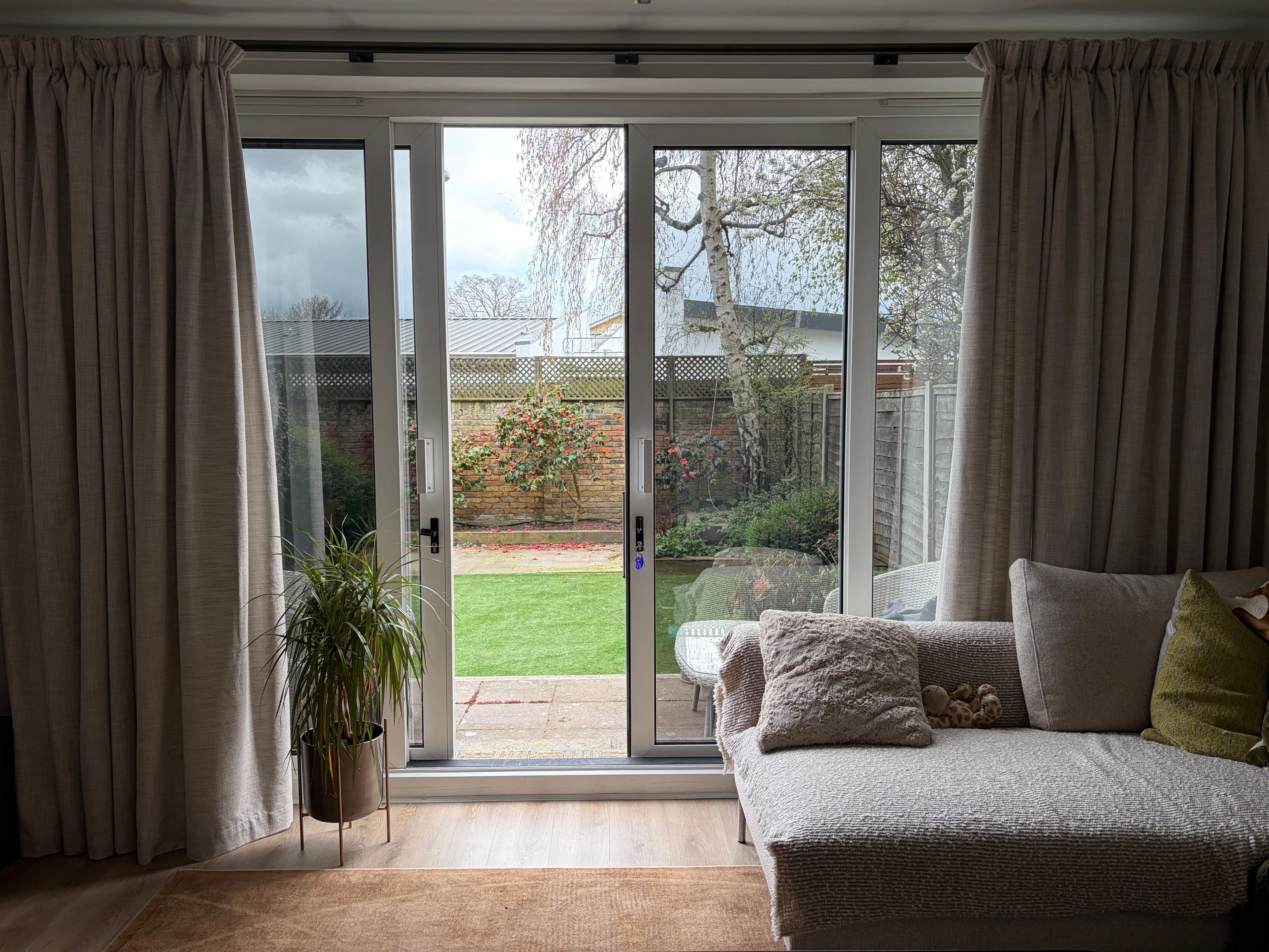 Exterior view of Marlow patio doors after Natural Sputtered film installation, showing clear reflections and full daytime privacy.